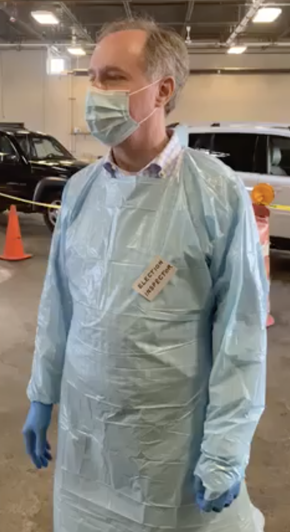 Assembly Speaker Robin Vos (R - Rochester), wearing surgical mask, gown and gloves, explaining how incredibly safe it is to vote in-person. 